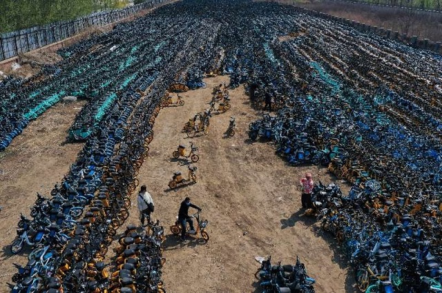 Rows of vibrant handlebars crisscross an open field just outside Shenyang, creating an unusual tableau—thousands of discarded